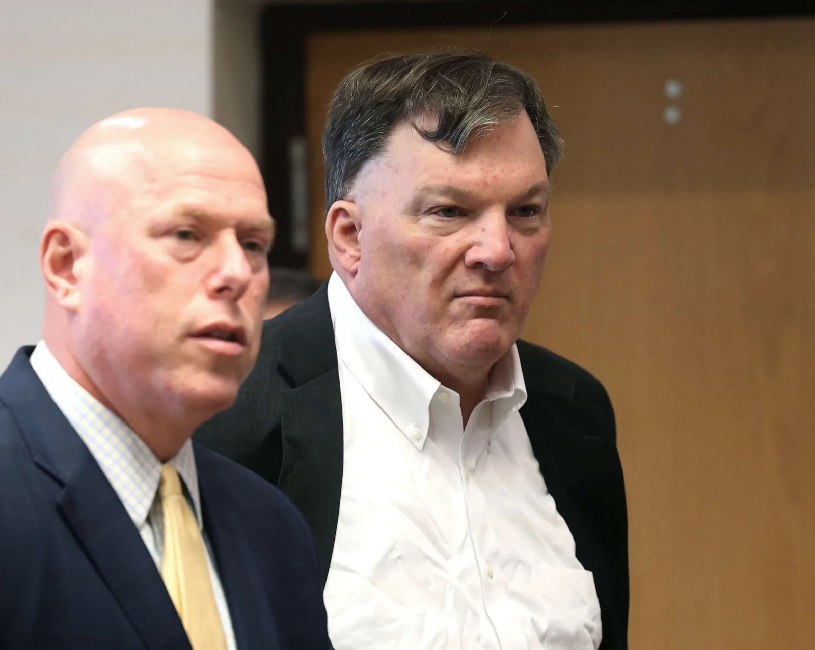 Rex Heuermann in a white shirt beside his lawyer in a Suffolk County courtroom