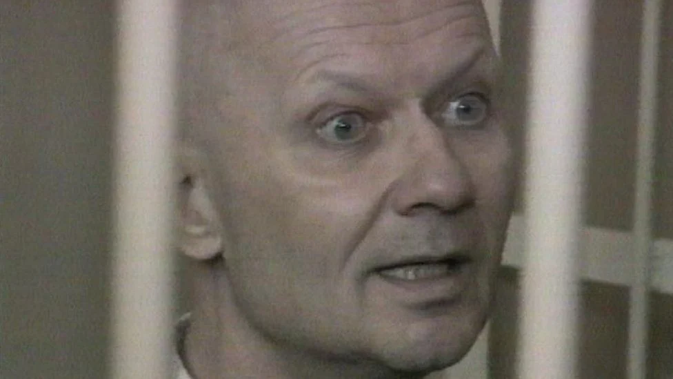 Mikhail Popkov in the defendants' cage of a Russian courtroom