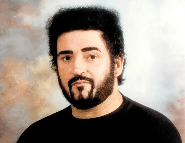Portrait photograph of Peter Sutcliffe with a dark beard and curly hair
