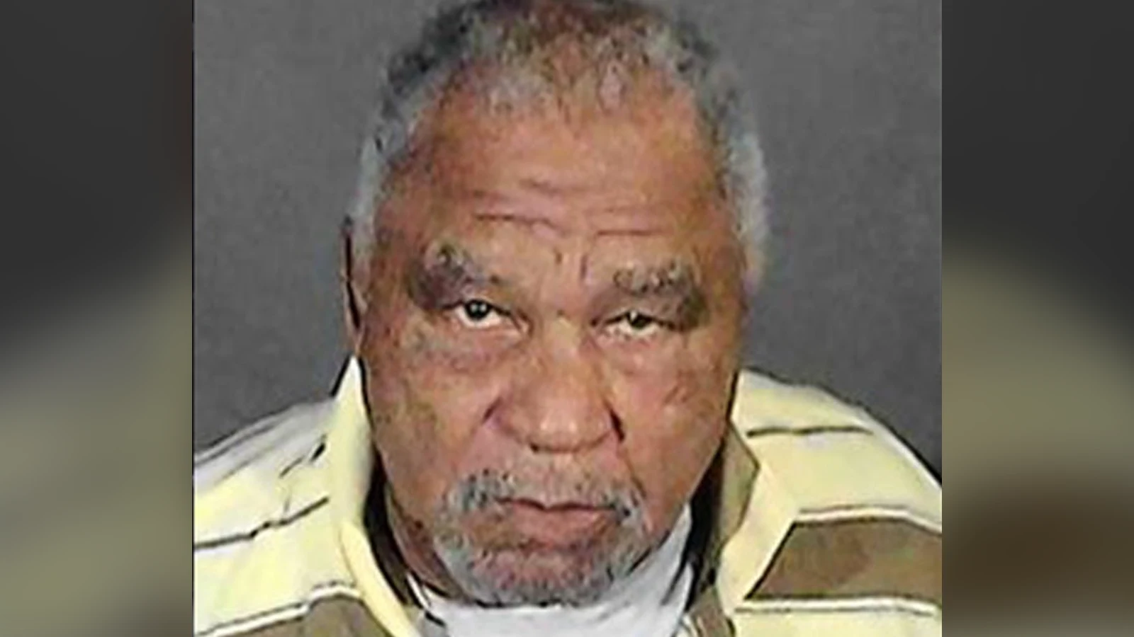 Samuel Little in a jail booking photograph, wearing a striped shirt