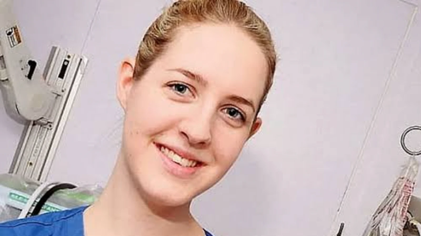 Lucy Letby in nurse's scrubs, smiling, in a hospital setting