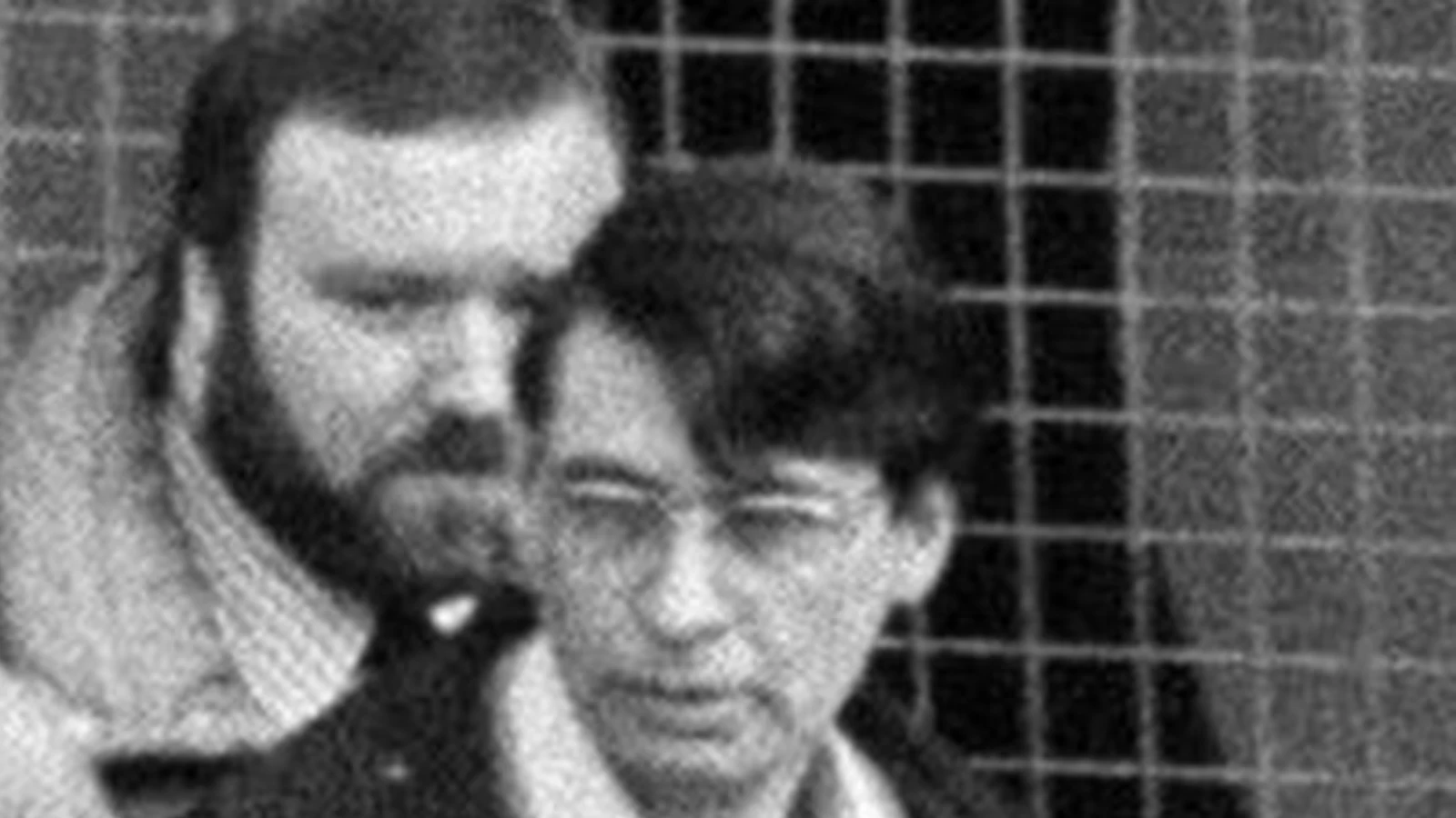 Dennis Nilsen, in glasses, led by plain-clothes police officers in 1983