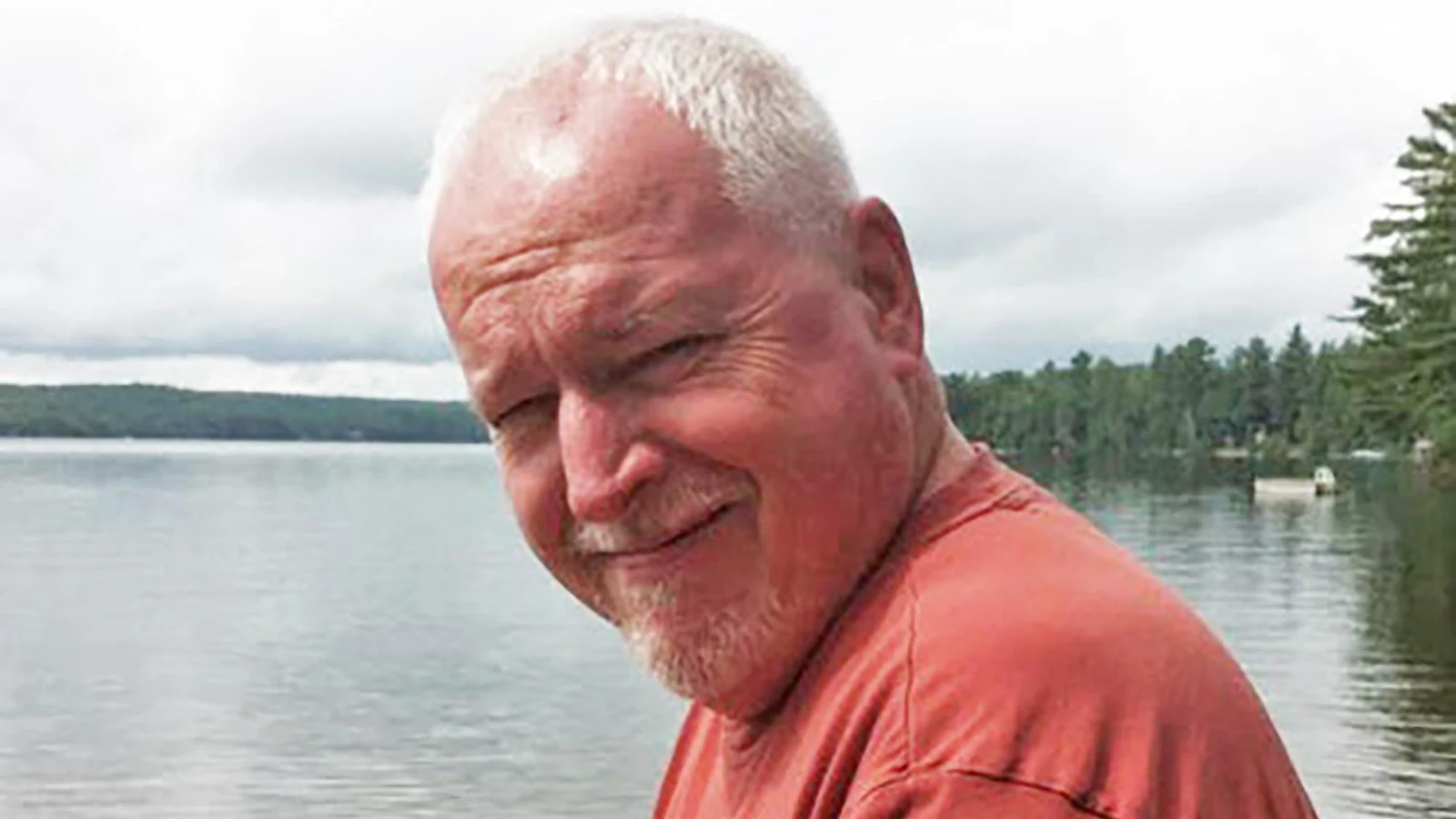 Personal snapshot of Bruce McArthur in a red T-shirt beside a lake, published by news outlets after his arrest