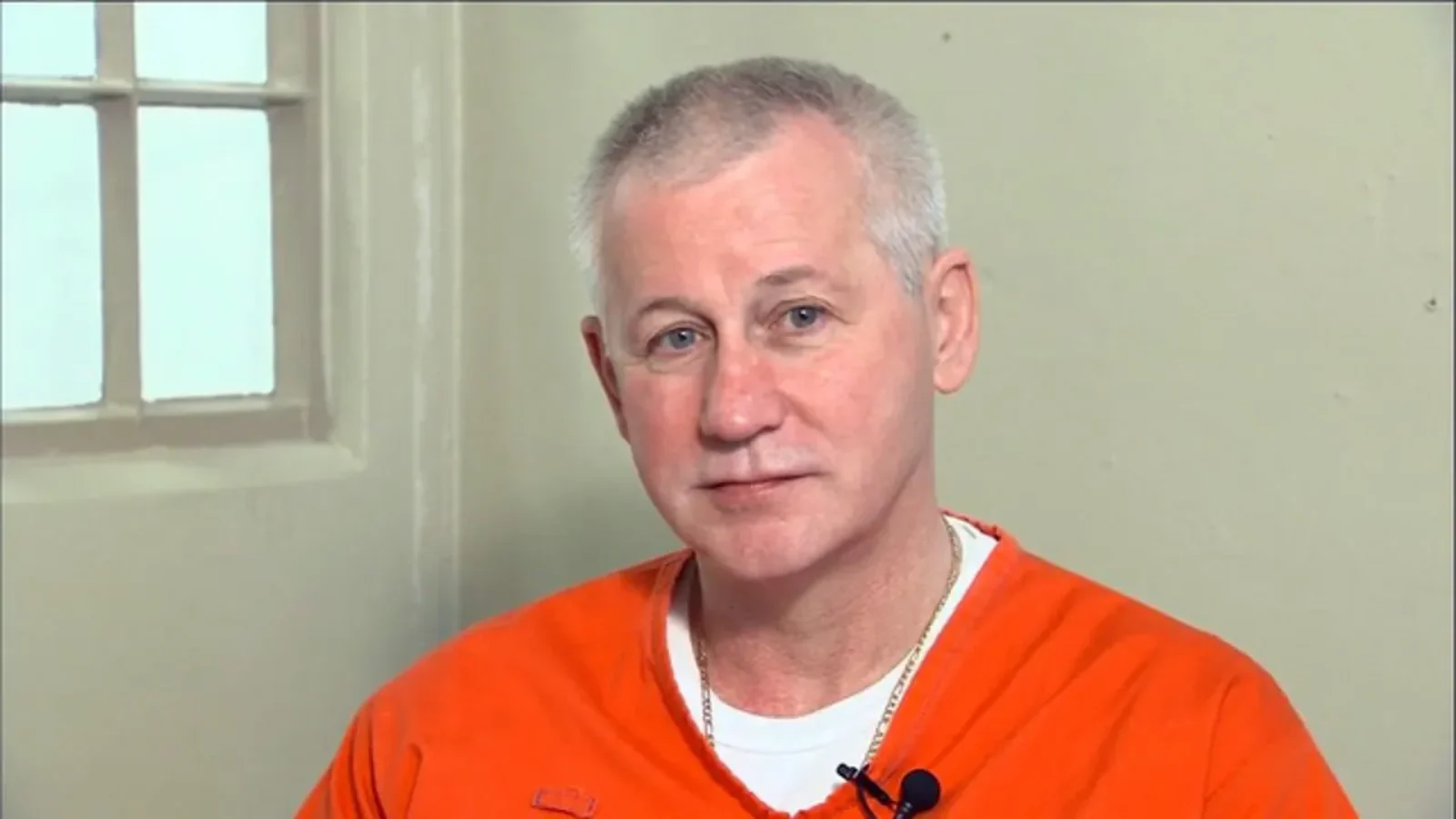Oscar Ray Bolin Jr. in an orange prison shirt during a television interview on death row
