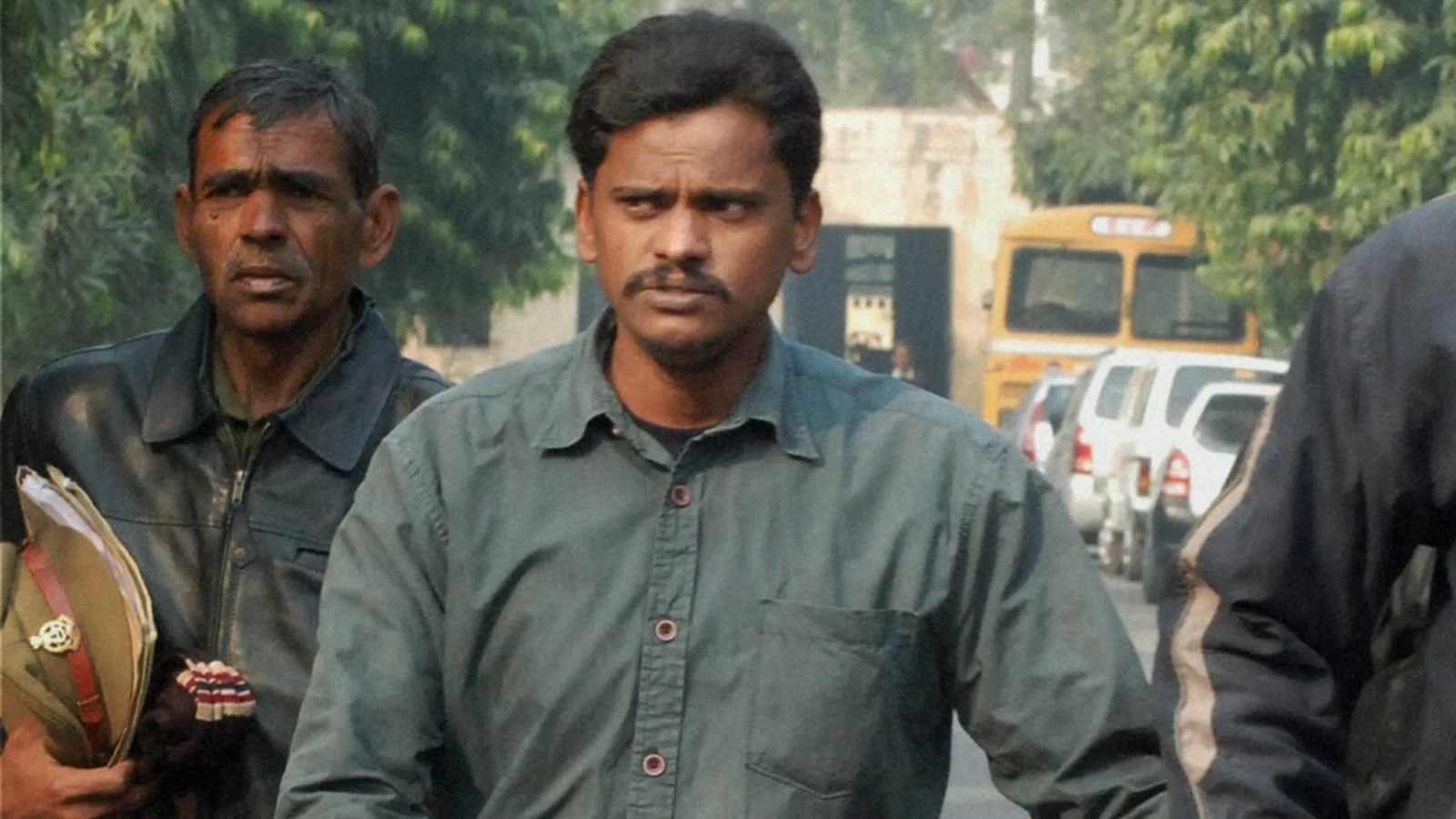 Surender Koli walking under police escort outside a court
