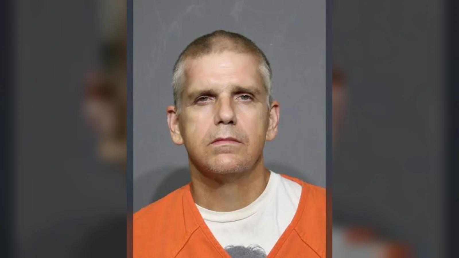Marshall Lee Gore in an orange prison uniform over a white T-shirt