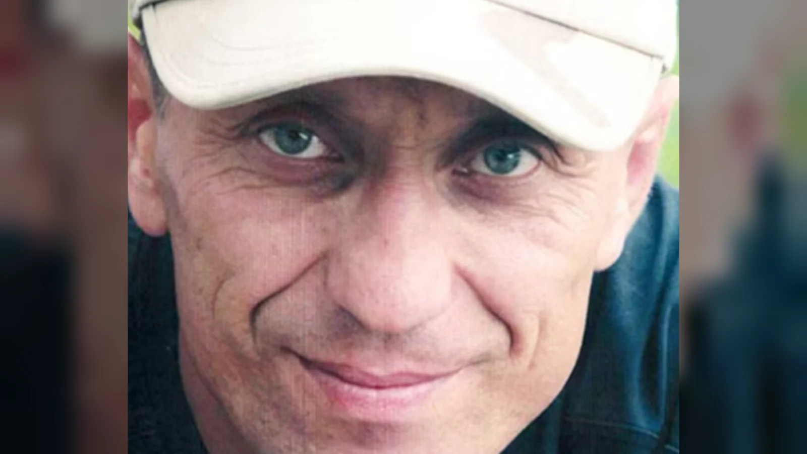 Mikhail Popkov, smiling, in a white baseball cap