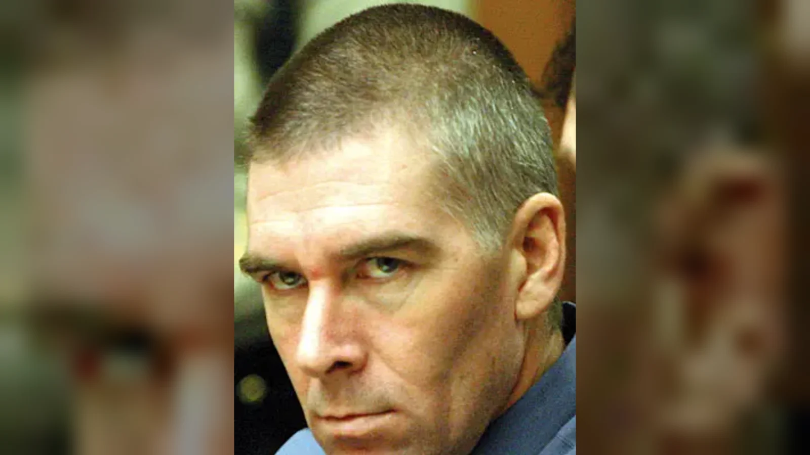 Loren Herzog, with close-cropped hair, in a courtroom