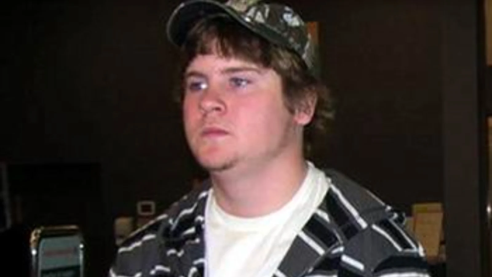 Cody Legebokoff in a camouflage cap and a striped hooded jacket