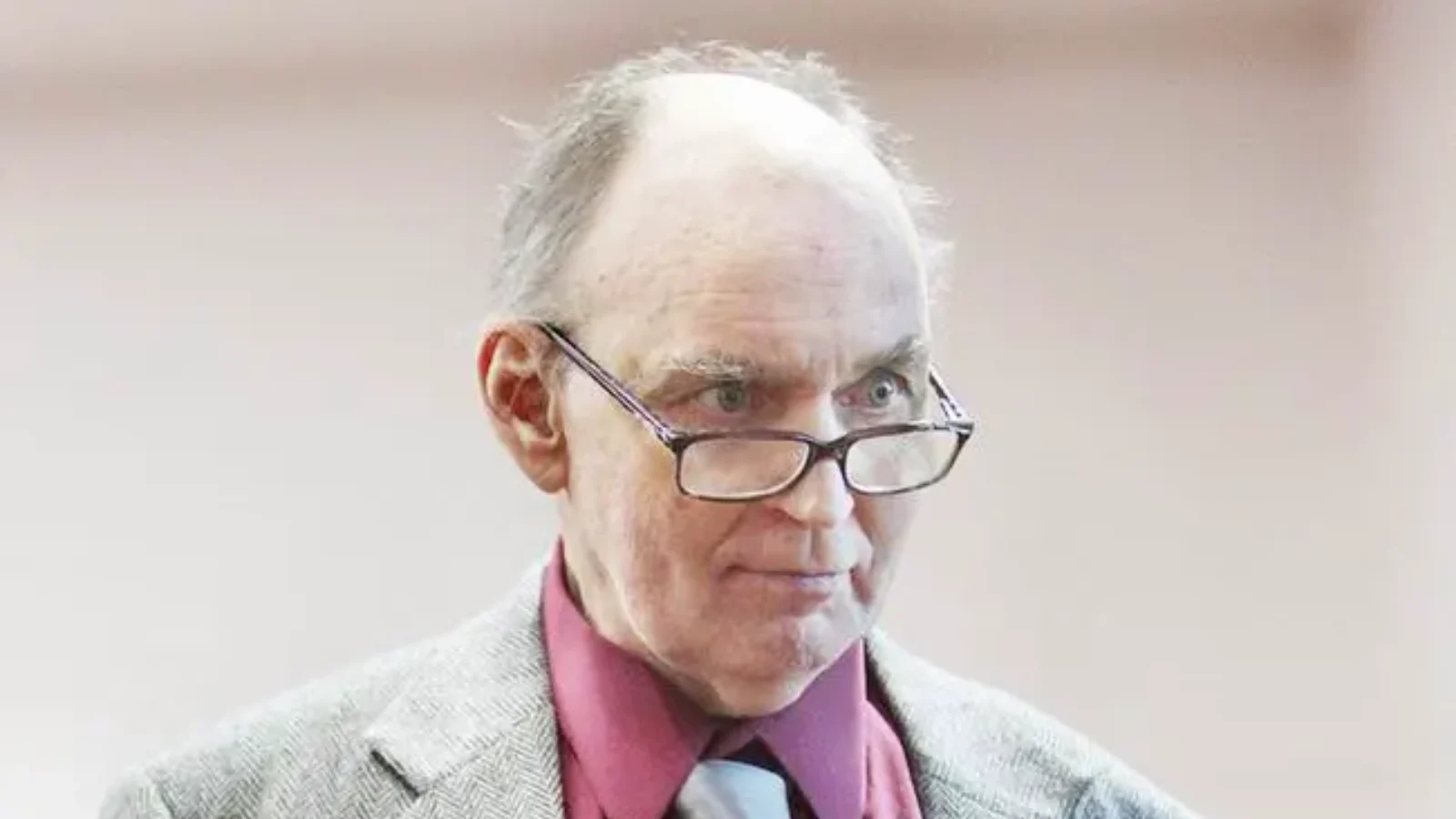 Gary Michael Hilton in glasses, a gray jacket and a red shirt in a Florida courtroom