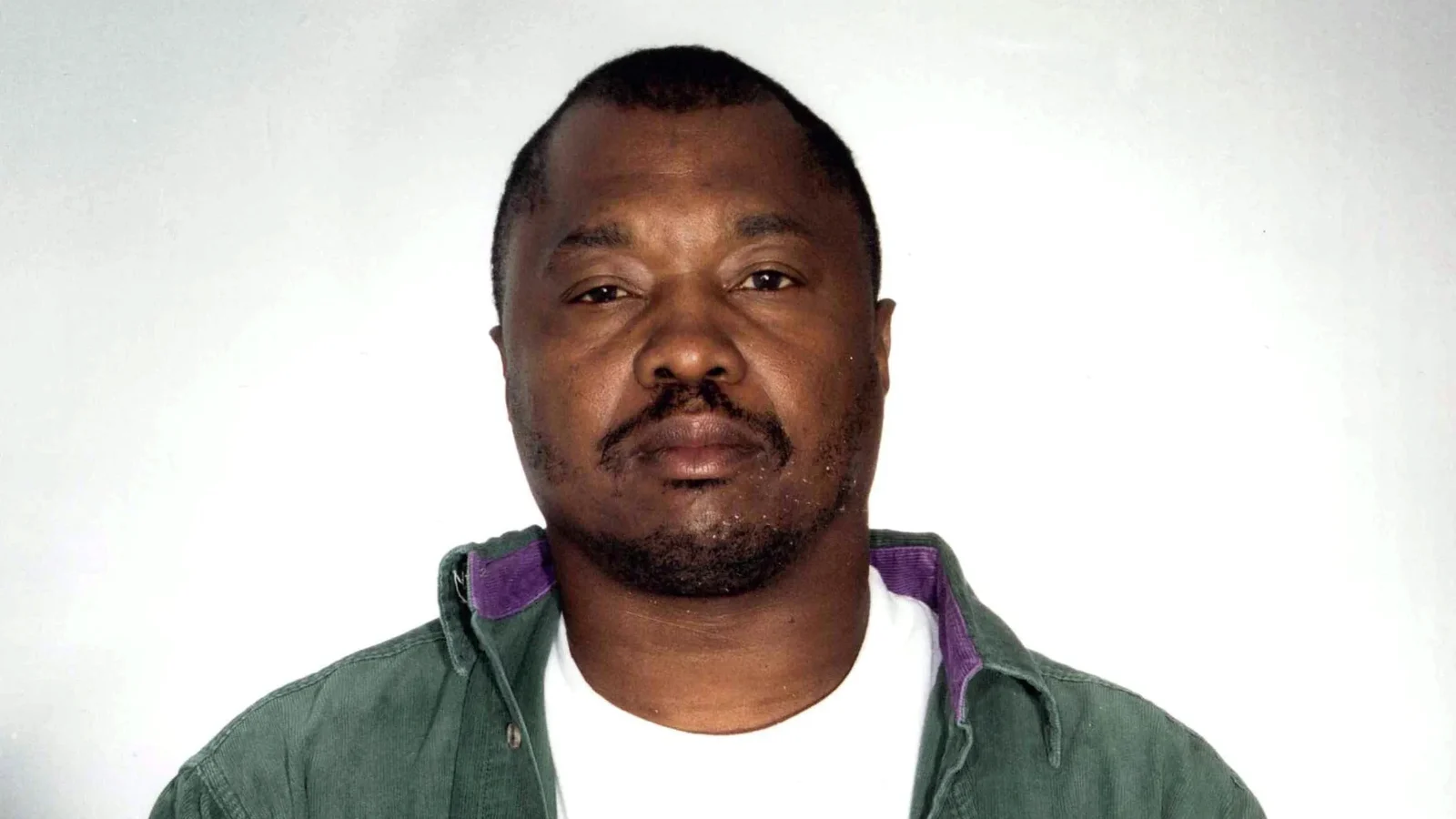 Lonnie Franklin Jr. in a green corduroy shirt over a white T-shirt in a 1998 Los Angeles police photograph