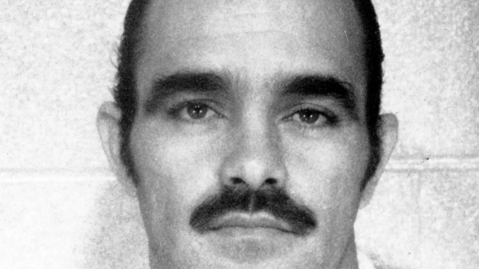 Timothy Krajcir with a mustache in an older black-and-white booking photograph