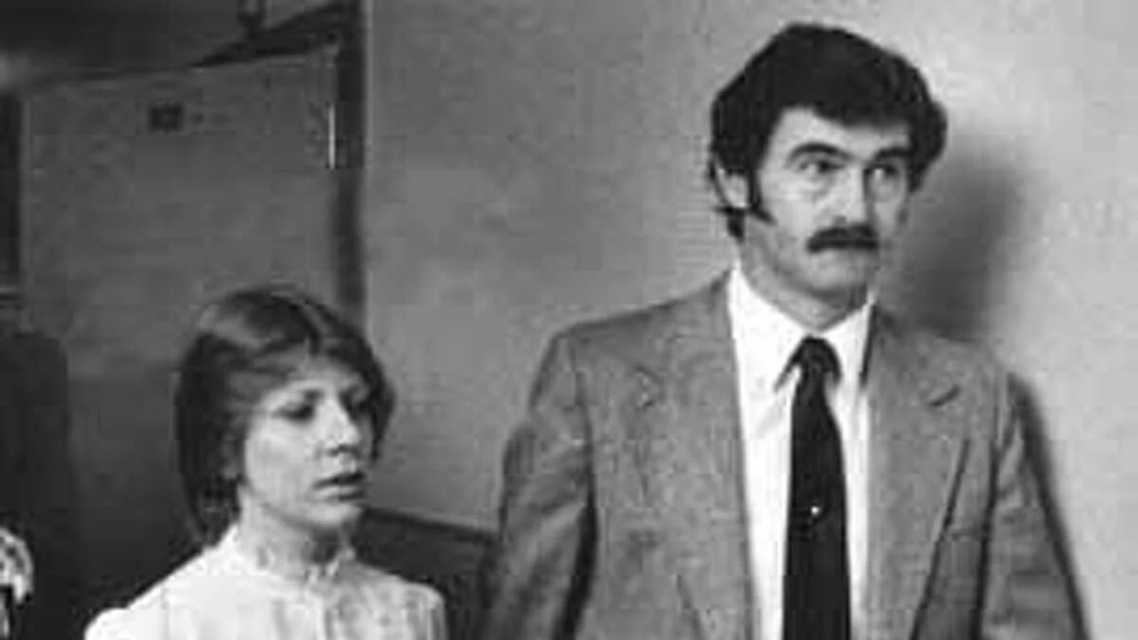 Gerald Gallego, mustached, in a suit and tie, beside Charlene Gallego in a white blouse, in a black-and-white photograph