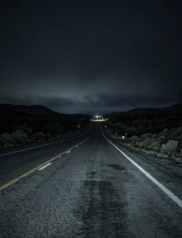 Illustration: an empty two-lane highway at night