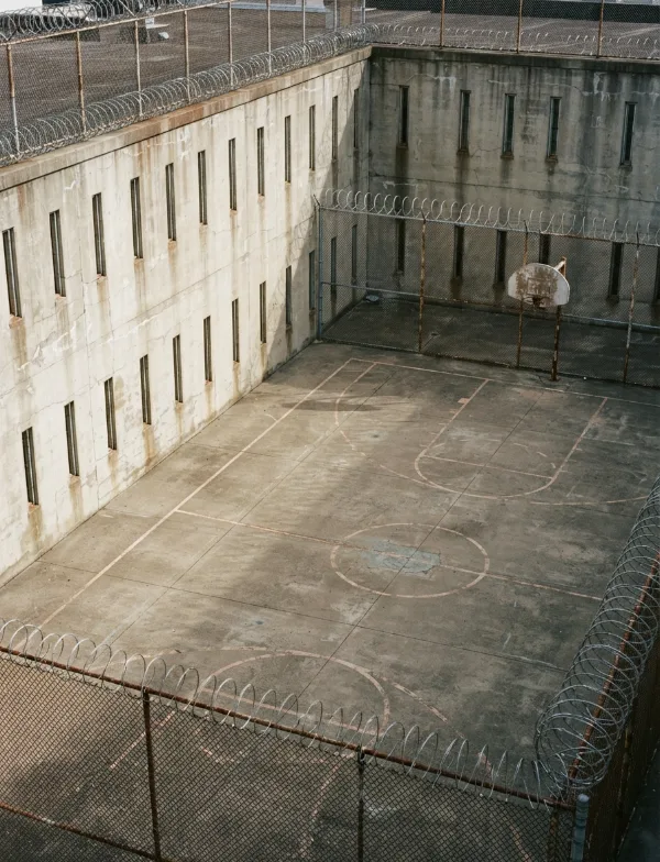 Illustration: empty prison exercise yard with basketball hoop seen from above